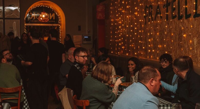 Customers sat chatting and eating pizza at Fratelli's.